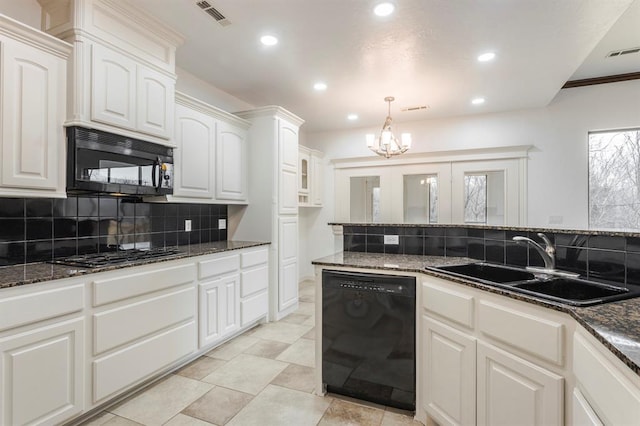 kitchen with sink, dark stone countertops, hanging light fixtures, black appliances, and white cabinets