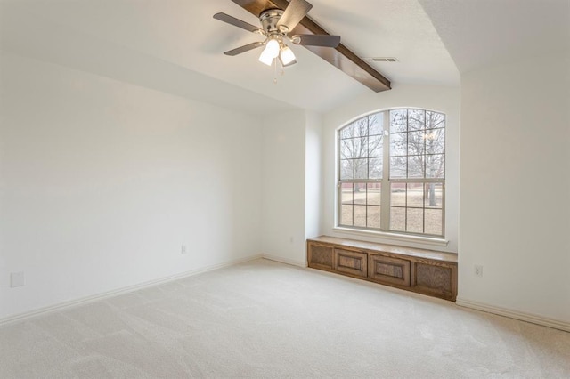 unfurnished room featuring ceiling fan, lofted ceiling with beams, and light carpet