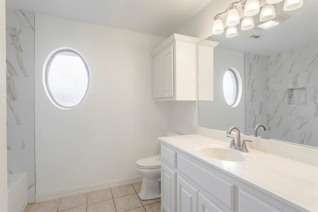 full bathroom featuring vanity, toilet,  shower combination, and tile patterned flooring