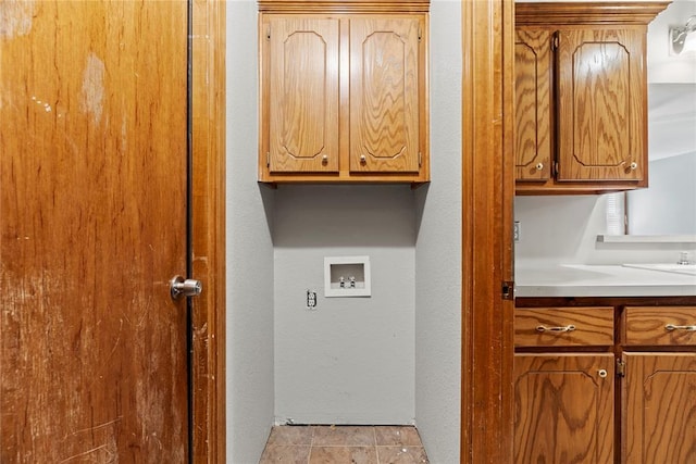 laundry room with cabinets and washer hookup