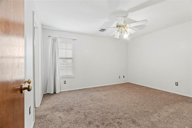 carpeted empty room featuring ceiling fan