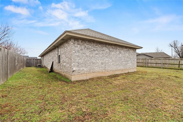 view of side of home featuring a yard