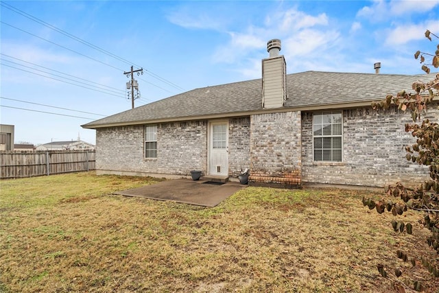 rear view of property with a lawn and a patio area