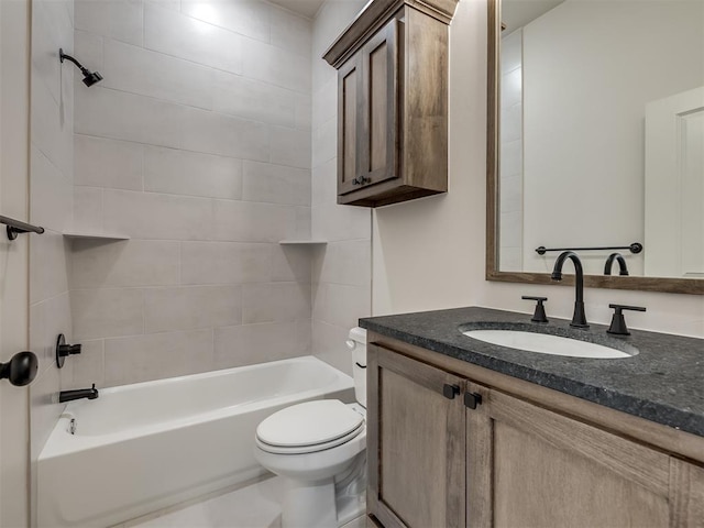 full bathroom featuring tiled shower / bath, vanity, and toilet