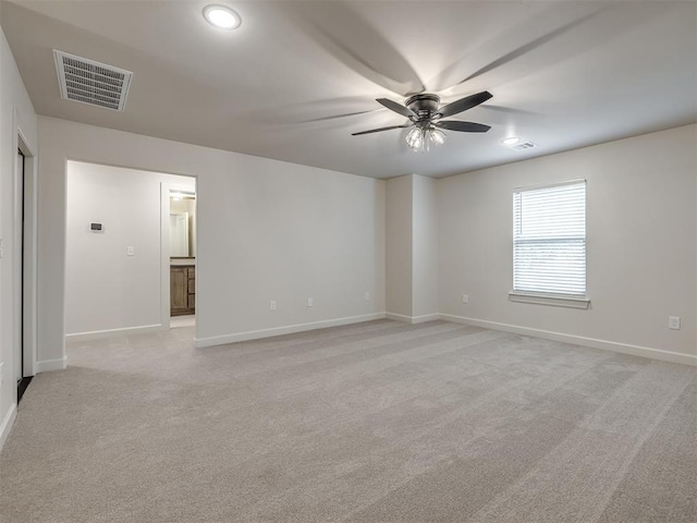 empty room featuring light colored carpet and ceiling fan