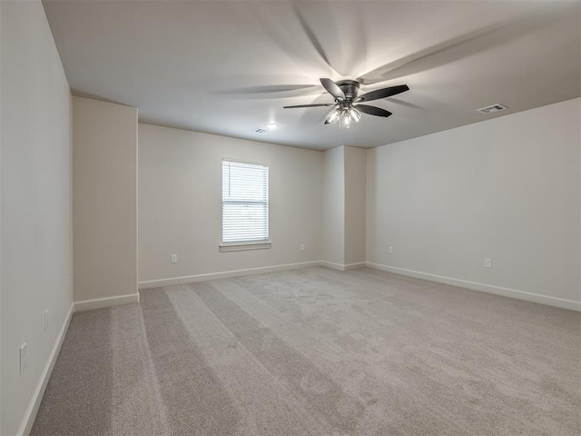 carpeted spare room with ceiling fan