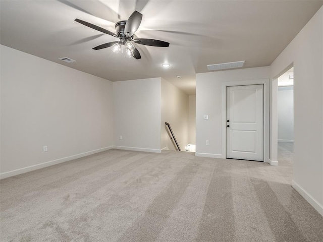 carpeted spare room with ceiling fan