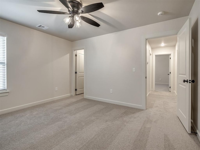 unfurnished room with light carpet and ceiling fan