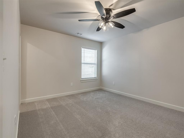 empty room with light colored carpet and ceiling fan