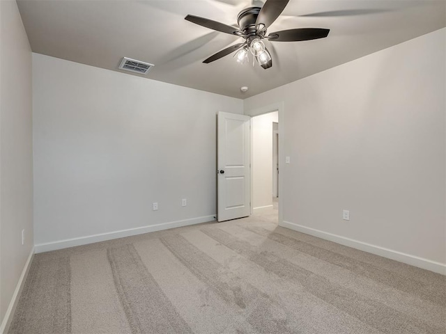 unfurnished room featuring light colored carpet and ceiling fan