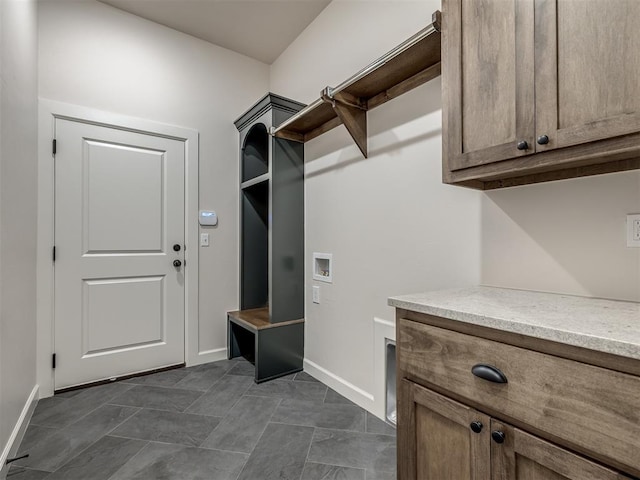 clothes washing area with cabinets and washer hookup