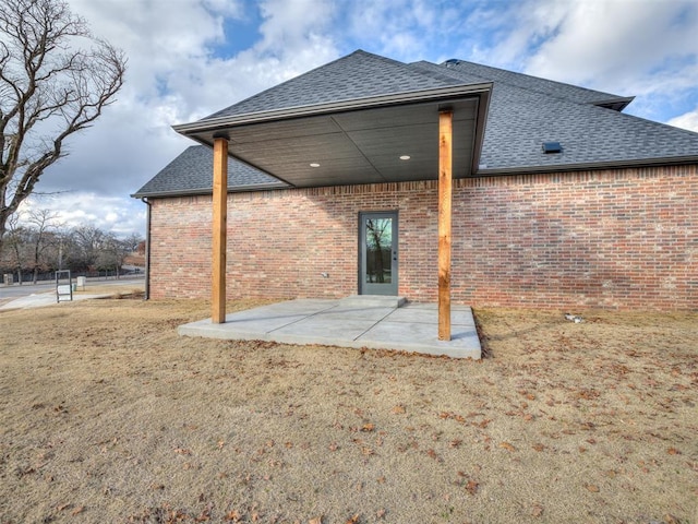 rear view of property with a patio and a yard