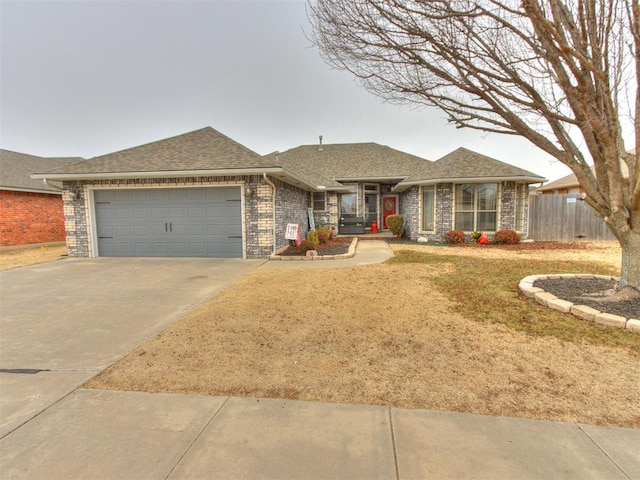 ranch-style house featuring a garage and a front lawn