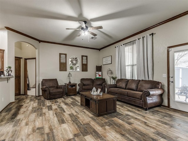 living room with dark hardwood / wood-style flooring, crown molding, and ceiling fan