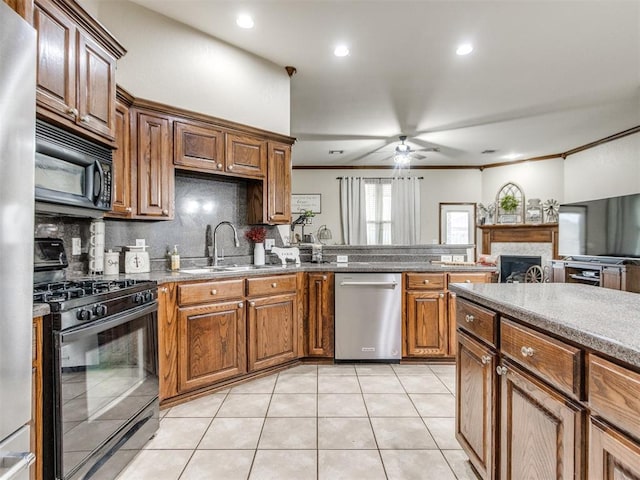 kitchen featuring light tile patterned flooring, tasteful backsplash, sink, ornamental molding, and black appliances