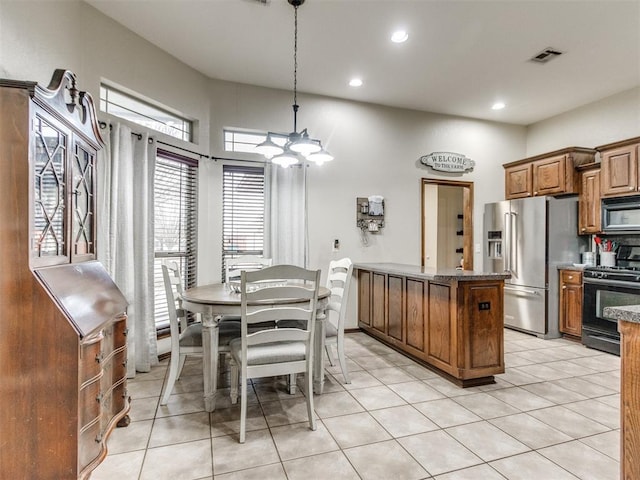 tiled dining area featuring an inviting chandelier