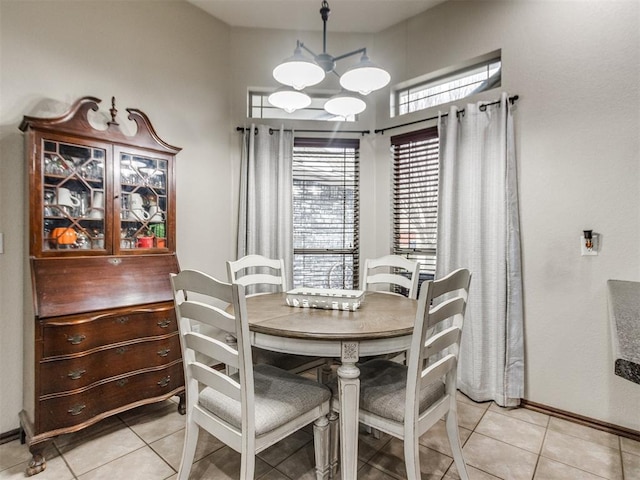 dining space featuring light tile patterned flooring and a chandelier