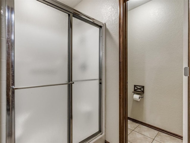 bathroom with tile patterned flooring and walk in shower