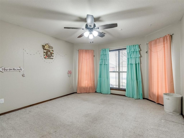 unfurnished room with light colored carpet and ceiling fan