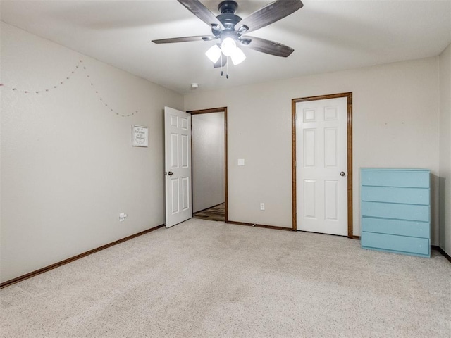 unfurnished bedroom featuring light carpet and ceiling fan