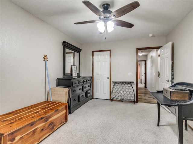 living area featuring ceiling fan and light colored carpet