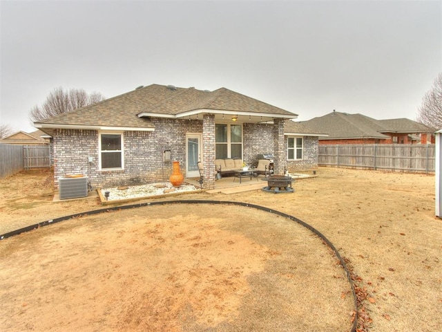 rear view of property with an outdoor fire pit, central AC unit, and a patio