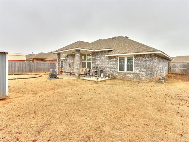 back of house featuring cooling unit, an outdoor fire pit, and a patio area