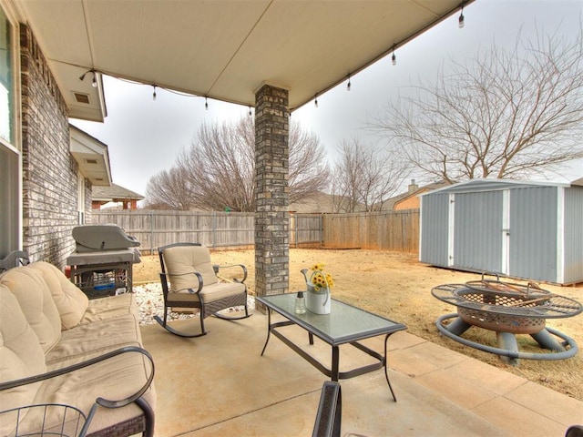 view of patio with a grill and a storage unit