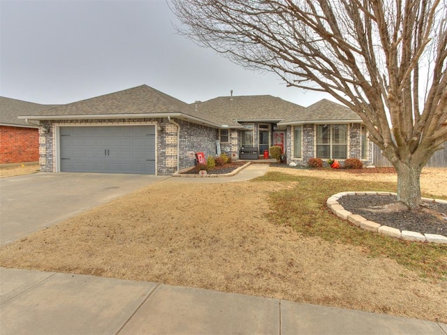 ranch-style house featuring a garage and a front lawn