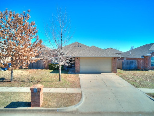 single story home with a garage and a front lawn