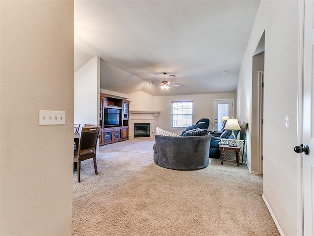 carpeted living room featuring vaulted ceiling and ceiling fan