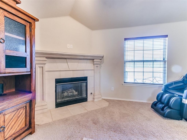 living room featuring a fireplace, vaulted ceiling, and light carpet