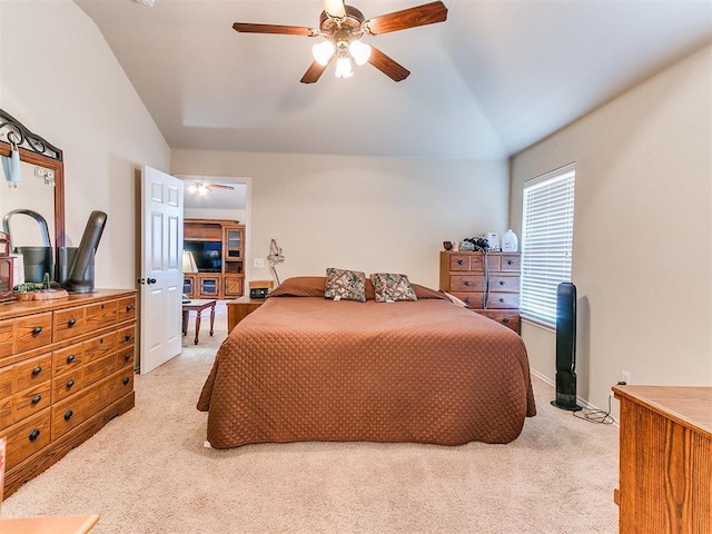 carpeted bedroom featuring lofted ceiling and ceiling fan