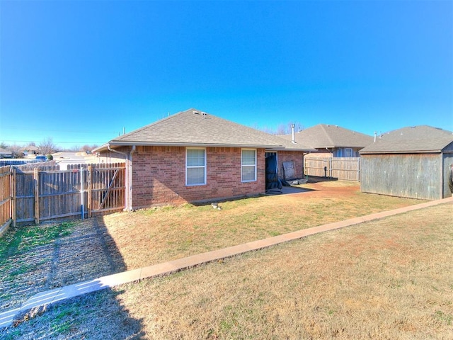 rear view of property featuring a yard