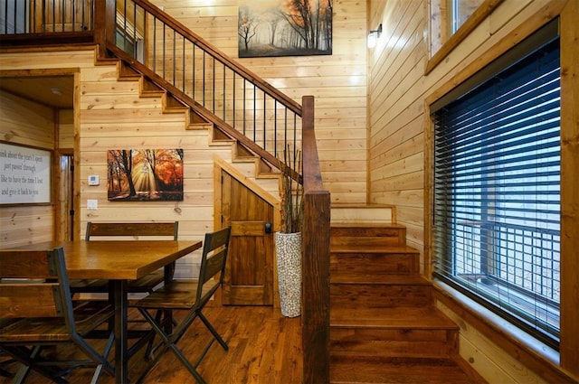 stairway with wooden walls and wood-type flooring