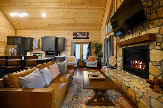 living room featuring dark hardwood / wood-style floors, wooden walls, high vaulted ceiling, and a stone fireplace