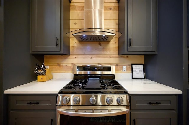 kitchen featuring gray cabinetry, gas range, and island range hood