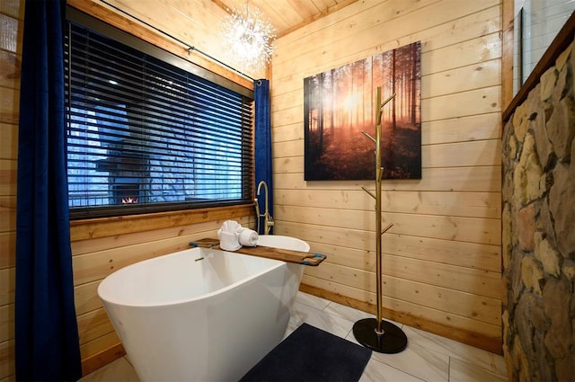 bathroom featuring a bath and wooden walls