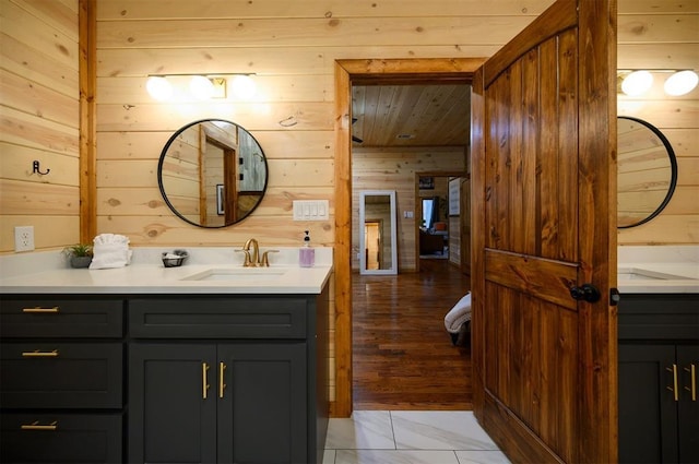 bathroom with vanity and wooden walls