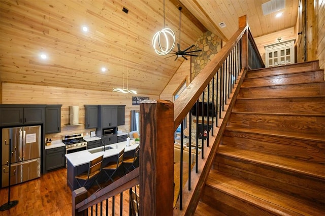 staircase featuring sink, wood ceiling, high vaulted ceiling, hardwood / wood-style flooring, and ceiling fan