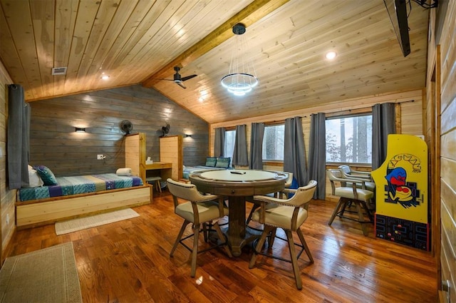 dining space with hardwood / wood-style flooring, vaulted ceiling with beams, wood ceiling, and wood walls