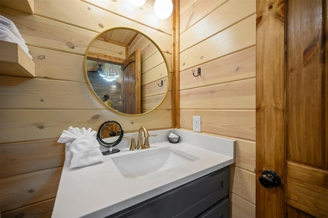 bathroom featuring vanity and wood walls