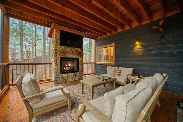 exterior space featuring beam ceiling and a fireplace