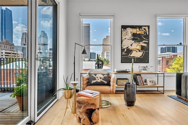 sitting room with a city view and wood finished floors