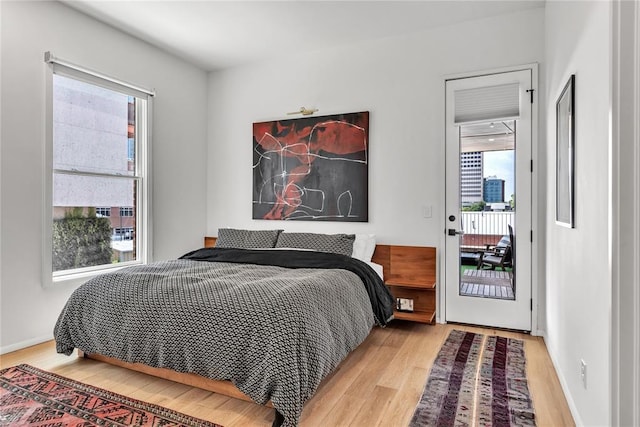 bedroom with baseboards and wood finished floors