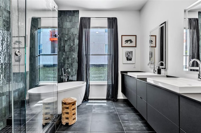 bathroom featuring a sink, a freestanding bath, a shower stall, tile patterned floors, and double vanity