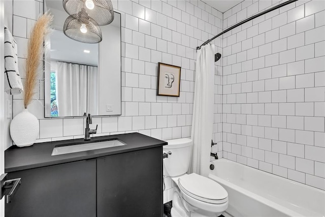 full bath with toilet, vanity, shower / bath combination with curtain, and tile walls