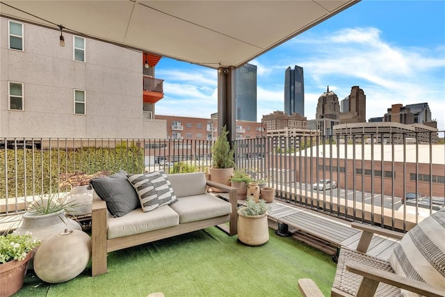 view of patio with a view of city, outdoor lounge area, and a balcony