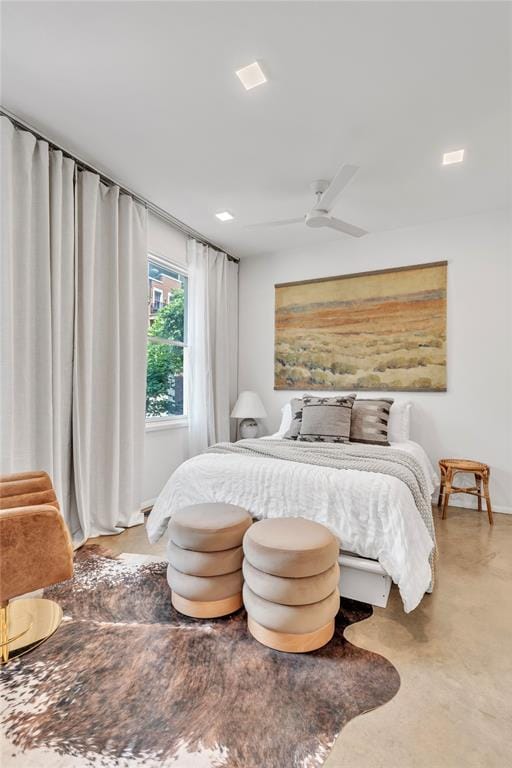 bedroom with ceiling fan and concrete floors