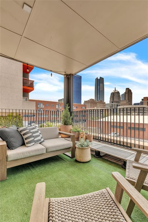 view of patio / terrace with an outdoor living space, a city view, and a balcony